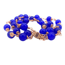 Load image into Gallery viewer, Blue beaded rose gold wire wrapped bracelet. Perfect for gifting. Donations for refugees in Austin Texas